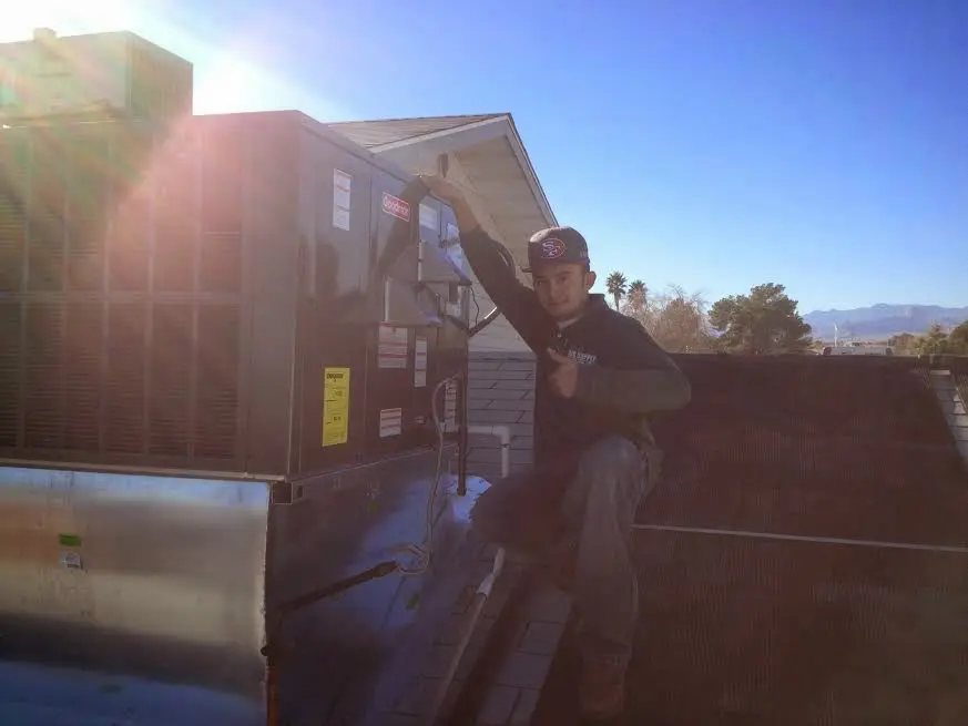 HVAC technician performing HVAC Inspection on a rooftop unit in Kingsport